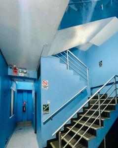 a staircase in a building with blue walls at Hotel Juan Diego Pucallpa in Pucallpa