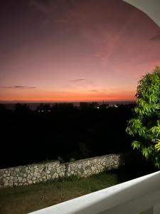 a sunset from the balcony of a house at Zuri Enterprise in Negril