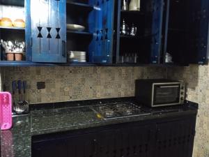 a kitchen with a counter with a microwave on it at Sultana duplex 1 pour les familles in Oualidia