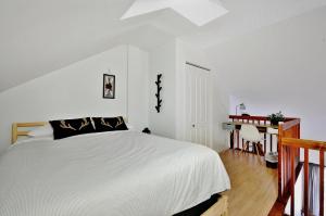 a bedroom with a white bed and a desk at Condo 305 33 Chemin du Hameau by Les Chalets Alpins in Stoneham