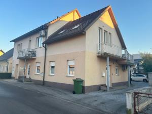 a building on a street with a trash can next to it at Tara's apartment in Vrhnika