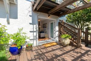 a porch with potted plants on a wooden deck at Laurelhurst - Cozy 1 Bedroom Apt Near Children’s Hospital and UW in Seattle