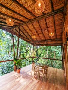 a dining room in a tree house with a table and chairs at Yogachal Vista Mar Bamboo House in the Jungle in Ojochal