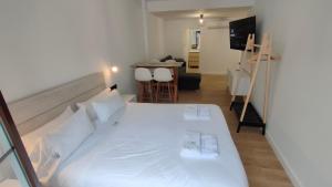 コルドバにあるMiRa San Basilioのベッドルーム(大きな白いベッド1台付)、キッチンが備わります。