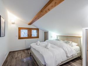 ein Schlafzimmer mit einem großen weißen Bett und einem Fenster in der Unterkunft Appartement Morzine, 5 pièces, 8 personnes - FR-1-754-14 in Morzine