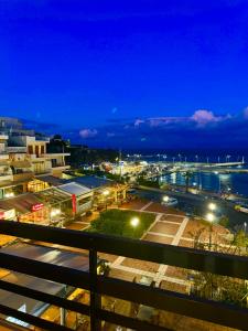 a view of a city at night at Blue Horizon Gem On The Port in Rafina