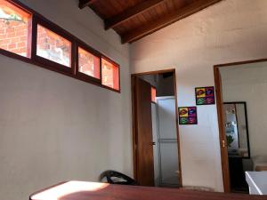 a room with a table and two windows and a door at apartasuite Centro Historico in Santa Fe de Antioquia