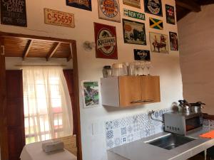 a kitchen with a sink and posters on the wall at apartasuite Centro Historico in Santa Fe de Antioquia