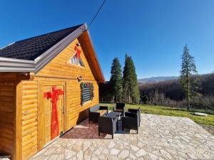 a small cabin with a red bow on it at Jerry's Cottage Banja Luka in Banja Luka