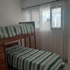 two bunk beds in a room with a window at DPTO PLAZA GODOY CRUZ in Godoy Cruz