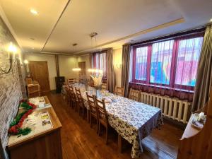 a dining room with a long table and chairs at Memo's Boutique Guesthouse in Karakol