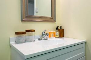 a bathroom with a sink and a mirror at Trail-side Haven Retreat! Pet friendly in North Haven +21 photos
