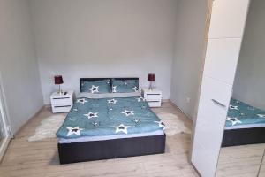 a bedroom with a bed and two night stands at The Train Stop in Târgu-Mureş