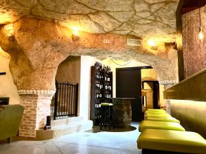 a wine tasting room with a stone wall at Casa cueva El Nido Casa Rural in Casas de los Teatinos