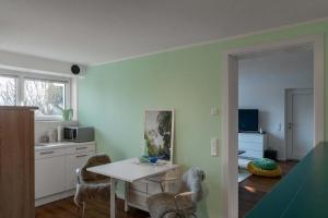 a kitchen with a table and chairs in a room at Sunshine River Flat in Hohentengen