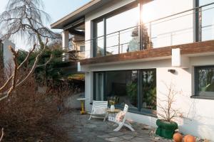 a house with large windows and a patio at Sunshine River Flat in Hohentengen