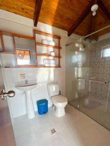 a bathroom with a toilet and a sink and a shower at Finca Villa Sophia! in Quimbaya