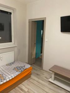 a room with a bed and a window and a table at Vlastná izba 5min od letiska in Bratislava