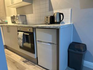a kitchen with a counter with two toasters on it at Ruxley Studios in Orpington