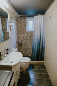 a bathroom with a sink and a toilet and a shower at INOHO Moka Maisonette in Xanthi
