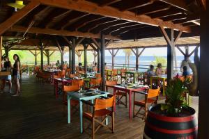 a restaurant with people sitting at tables and chairs at Studio Bruni Lodge in Sainte-Anne