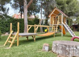 a playground with a play house and a slide at Casa Rural La Laguna in Catral