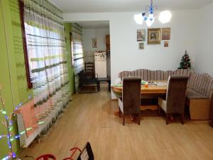 a dining room with a table and a christmas tree at Apartman Zivic in Berilovac +18 photos