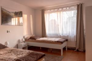 a bedroom with two beds and a window at Ferienwohnung in Kassel