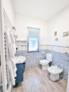 a bathroom with a toilet and a sink at Le Giare B&B in Levanto