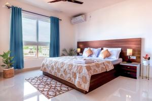 a bedroom with a large bed and a large window at Borail Homes in Silchar
