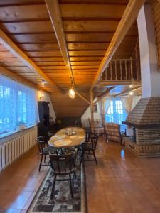 a dining room with a wooden table and chairs at Beskidzka Apartments in Sucha Beskidzka