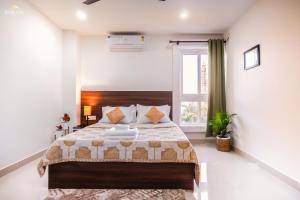 a bedroom with a bed and a window at Borail Homes in Silchar