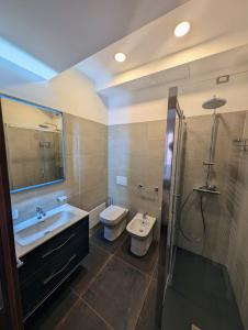 ein Bad mit einem Waschbecken, einem WC und einer Dusche in der Unterkunft Benedict Rooms in Bologna