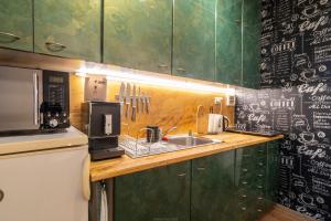 a kitchen counter with a sink and a microwave at Double-tree apartment by A&M in Bratislava