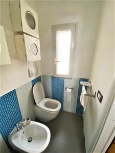 a small bathroom with a toilet and a sink at La Terrazza Bella Sicula in Furci Siculo