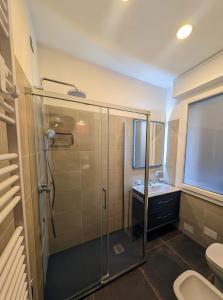 a bathroom with a shower and a toilet and a sink at Benedict Rooms in Bologna