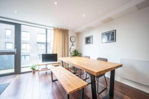 a dining room with a table and a large window at Pass the Keys Boutique Peckham Flat 12 mins to London Bridge in London