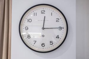 a black and white clock on a wall at Pass the Keys Boutique Peckham Flat 12 mins to London Bridge in London