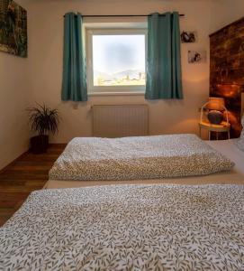 A bed or beds in a room at Haus Faninger - Summercard included