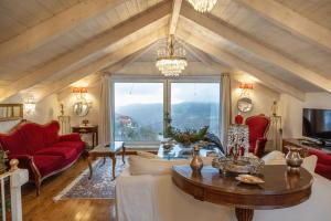 a living room with a table and a large window at Penelope suite 