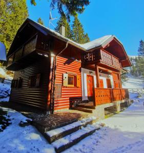 a log cabin with snow on the ground at Apartma Smučišče Krvavec in Cerklje na Gorenjskem