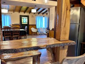a kitchen and dining room with a large wooden table at Alma Andina in El Calafate