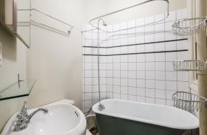 a bathroom with a bath tub and a sink at Lovely 5Bedroom apartment in NYC! in New York
