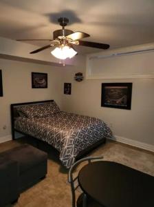 a bedroom with a bed and a ceiling fan at Lovely 5Bedroom apartment in NYC! in New York