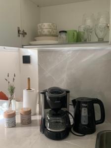 a black coffee maker sitting on a kitchen counter at Las Tipas mini loft Cafayate in Cafayate