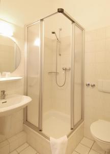 a bathroom with a shower and a sink at Hotel Münchner Löwenbräu in Cuxhaven +34 photos