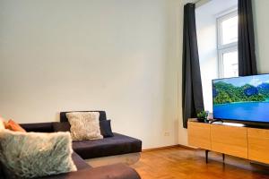 a living room with a couch and a flat screen tv at Beautiful Apartments Near Hauptbahnhof in Vienna