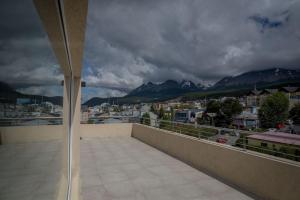 a balcony with a view of a city and mountains at Ushuaia Center Apartament Suit in Ushuaia