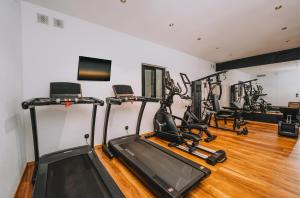 a gym with treadmills and elliptical machines at Ftelia Black Villas in Ftelia