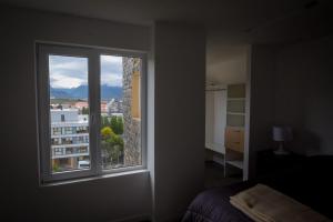a bedroom with a window with a view of a city at Ushuaia Center Apartament Suit in Ushuaia